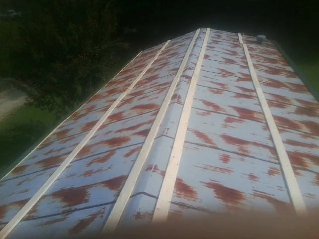Rusted metal roof panels with new wood purlins before replacement — Storm Damage Roof Repair in Canaan by Roofing Brothers